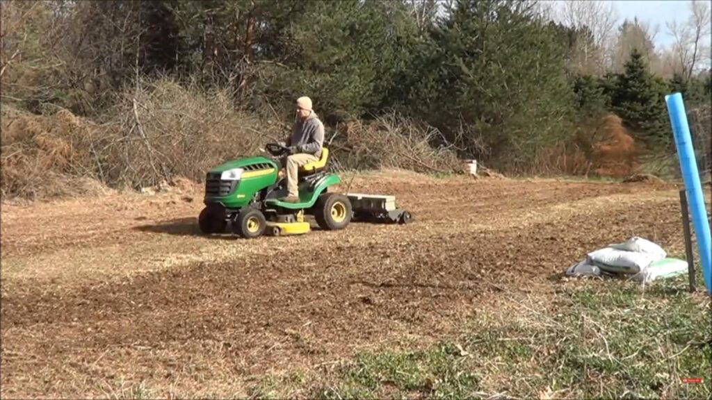 Using a pull behind dethatcher to prep the soil for planting food plot seeds.